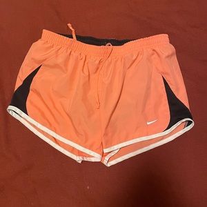 Peach Nike running shorts